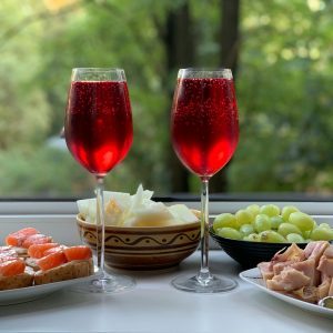 two wine glasses with red wine on table