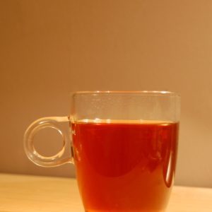 clear glass mug with brown liquid